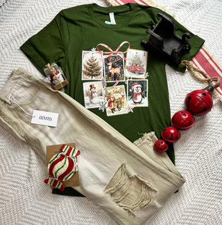 Green t-shirt with festive design, beige pants, and Christmas decorations on a textured surface.